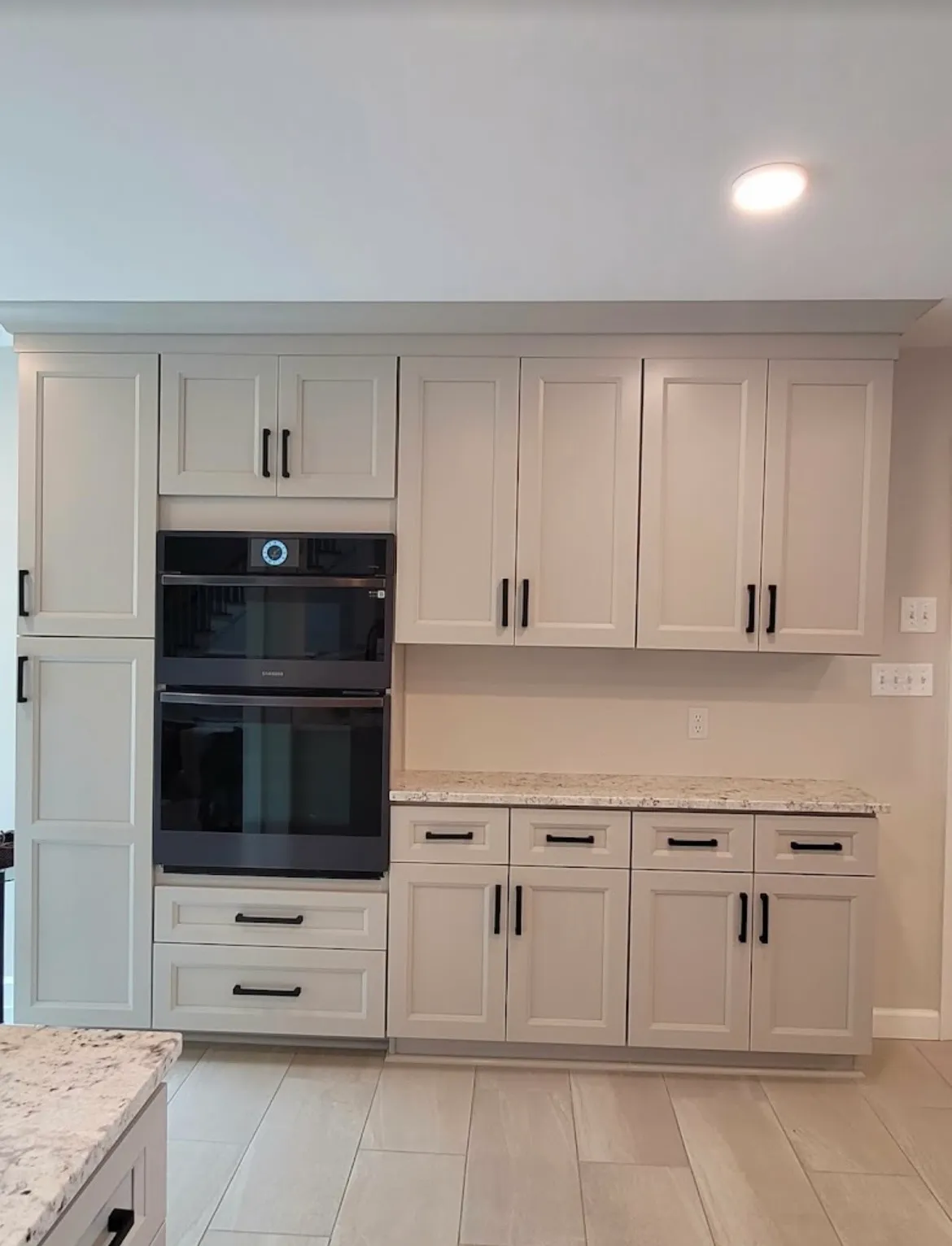 Kitchen remodel with tall pantry cabinets and built-in double wall oven