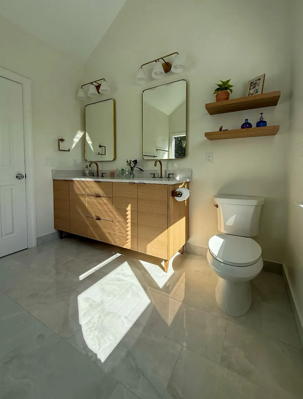 Bathroom remodel with double vanity and floating shelves