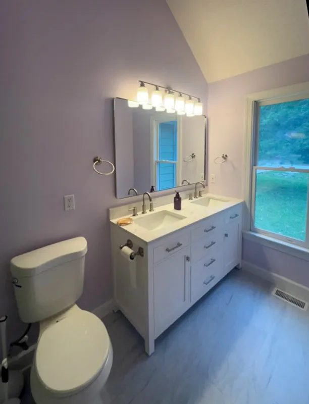 Bathroom remodel double vanity beside a tall window
